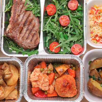 Different containers with delicious food as background. Delivery service